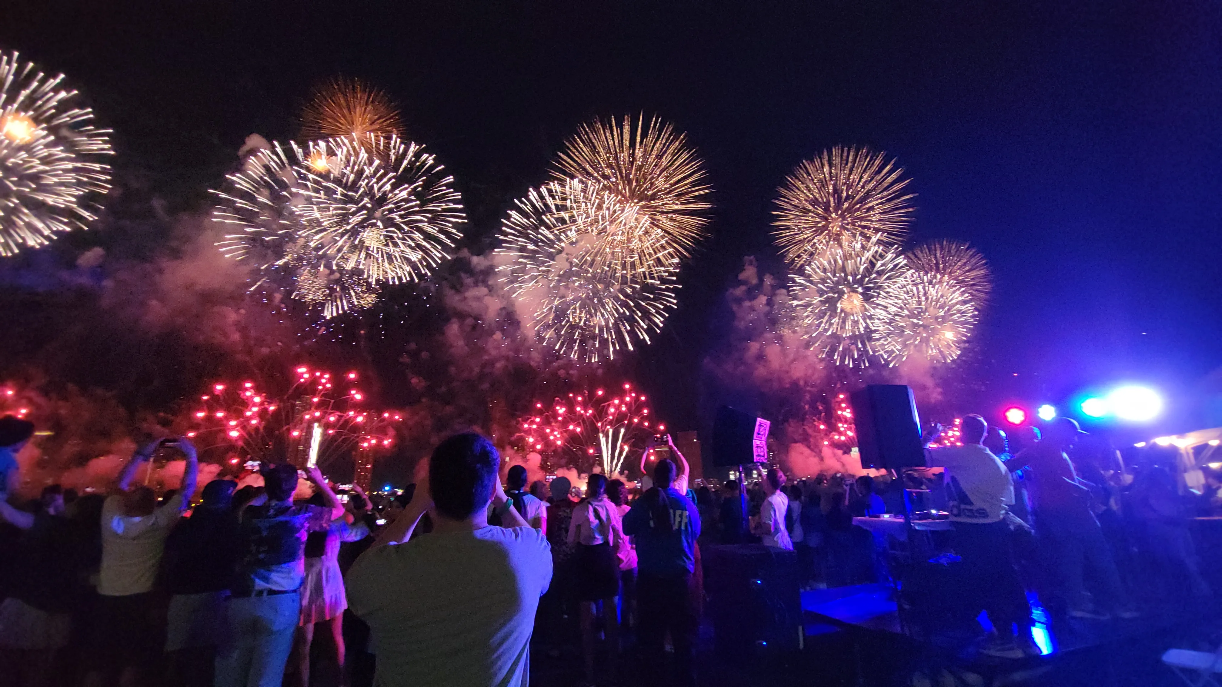 Front Row Fireworks crowd celebrating with DJ and spectacular fireworks overhead